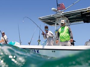 Recreational anglers fish from a boat in the waters of Key Largo, Florida. 